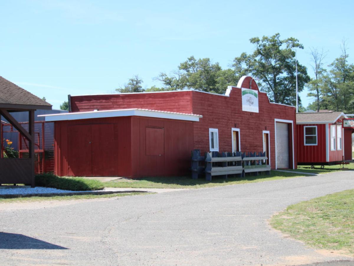 a large brick building with grass in front of a house